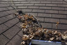 cleaning your gutters 220x147 5 Steps for Maintaining Your Roof!